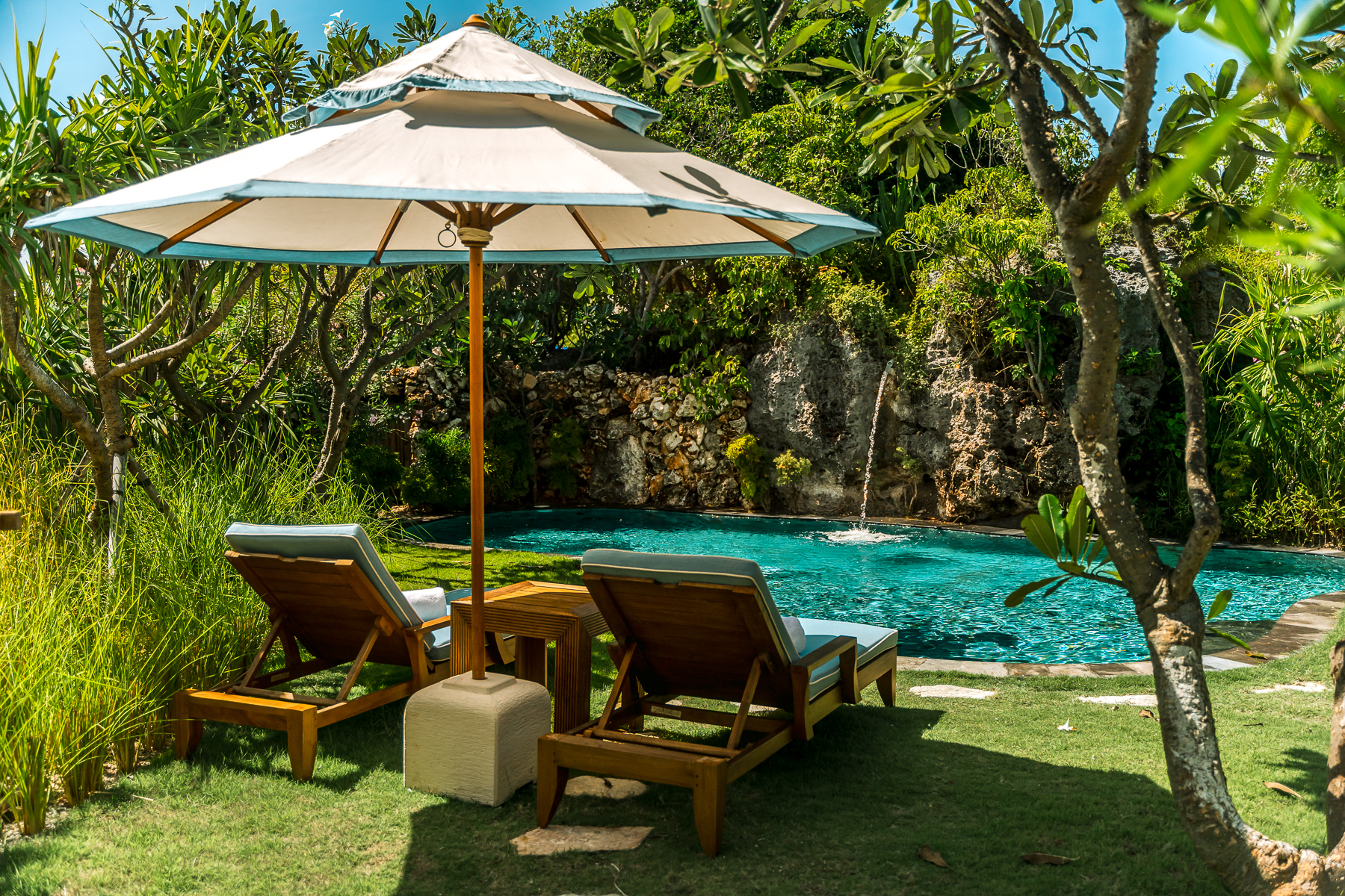 Loungers at a waterfall pool at NIHI Rote in Indonesia