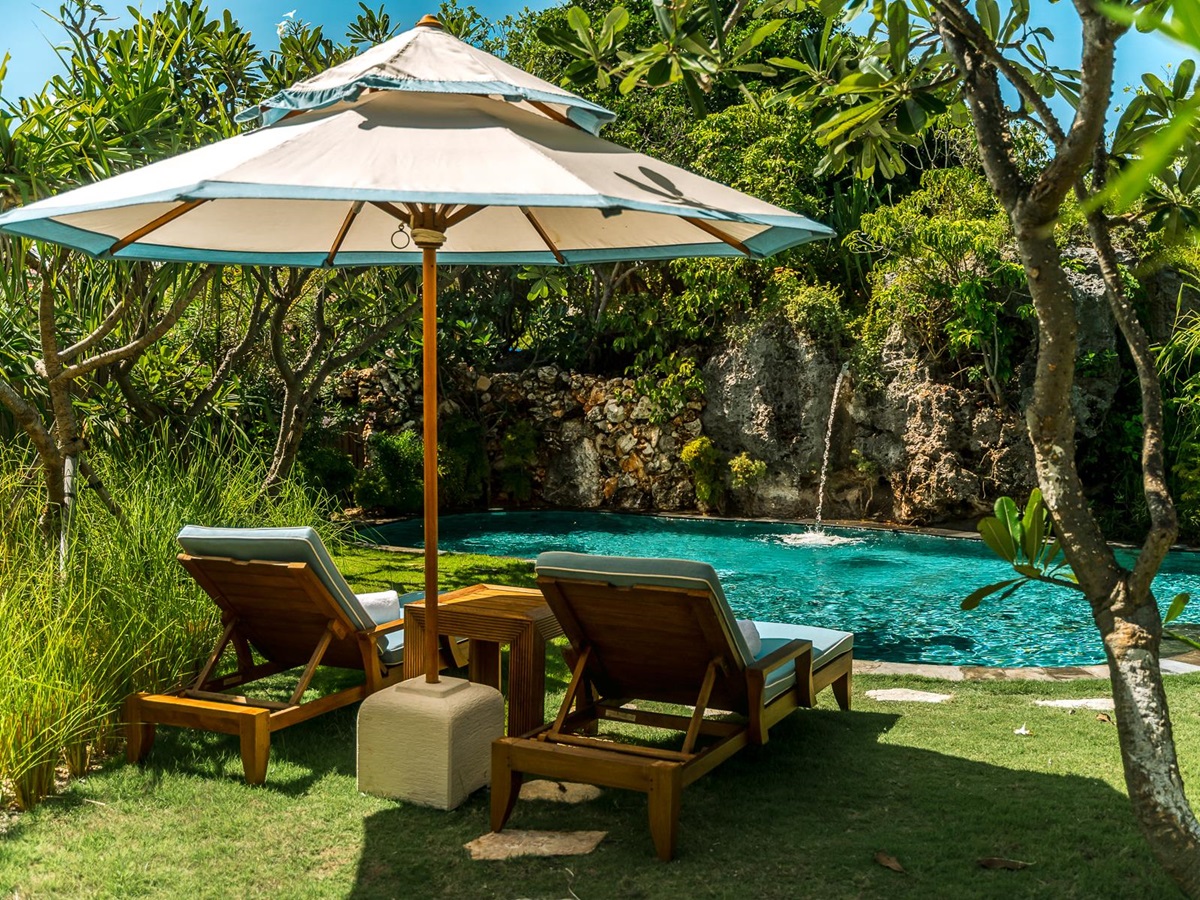 Loungers at a waterfall pool at NIHI Rote in Indonesia
