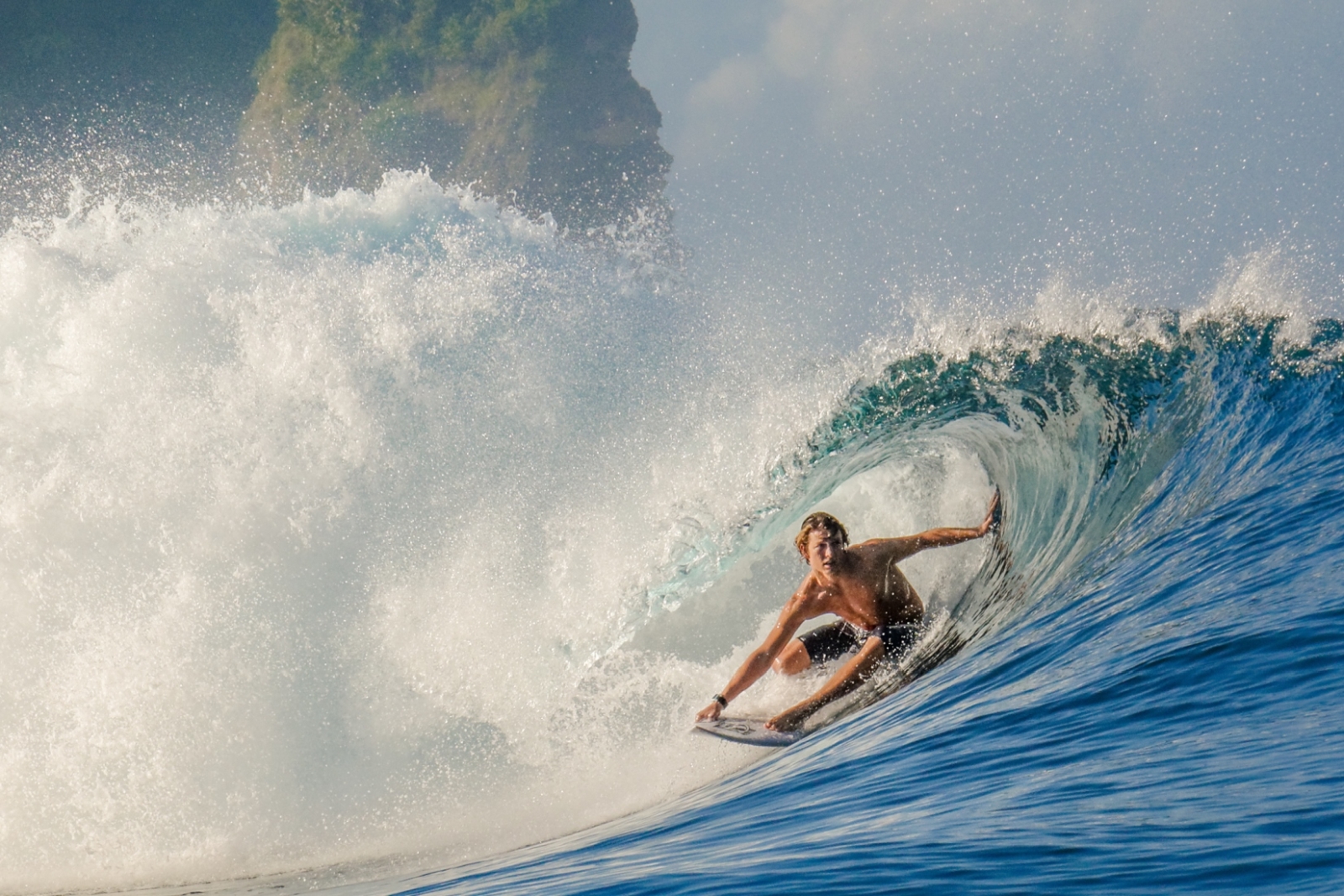 Surfer riding a wave at Nihi Sumba