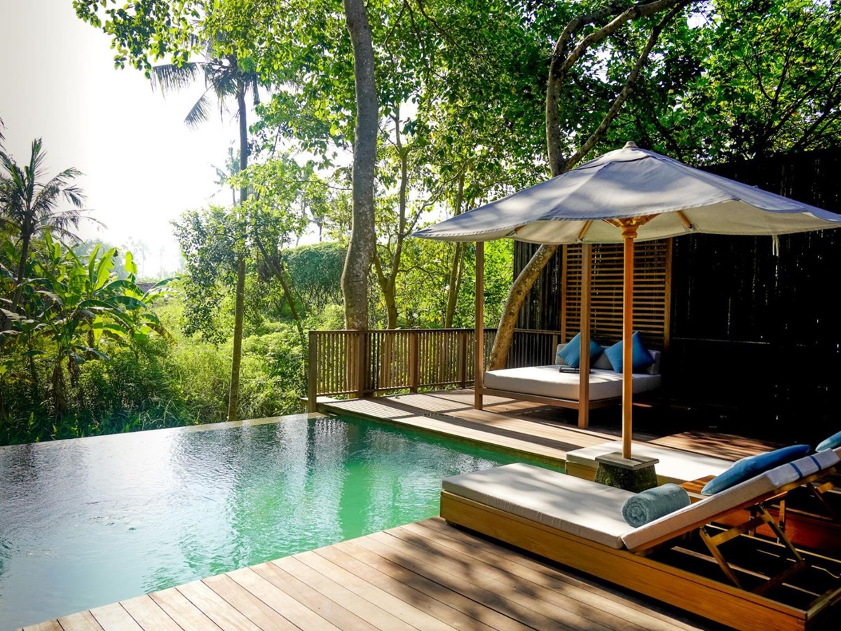 Residence swimming pool and loungers at Nirjhara luxury resort in Bali