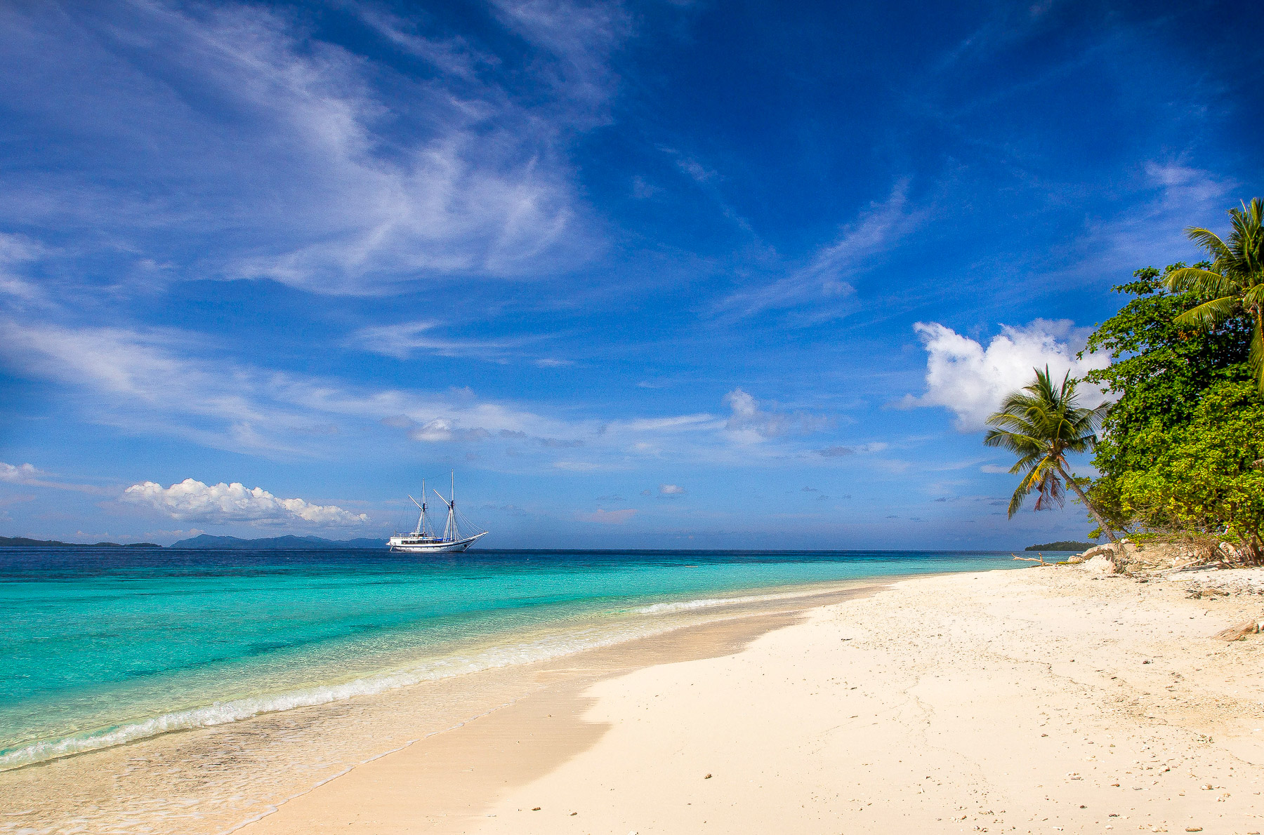 Ombak Putih moored near the beach in Raja Ampat