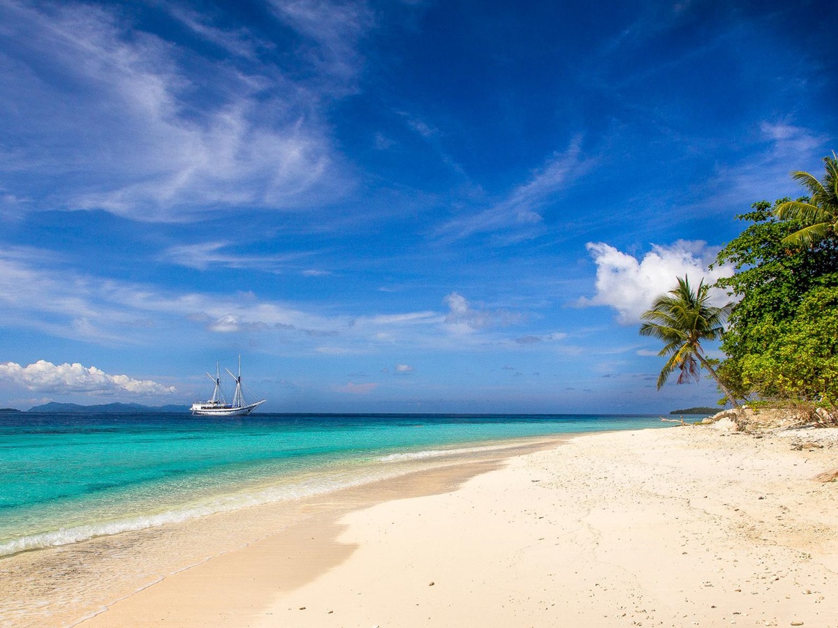 Ombak Putih moored near the beach in Raja Ampat