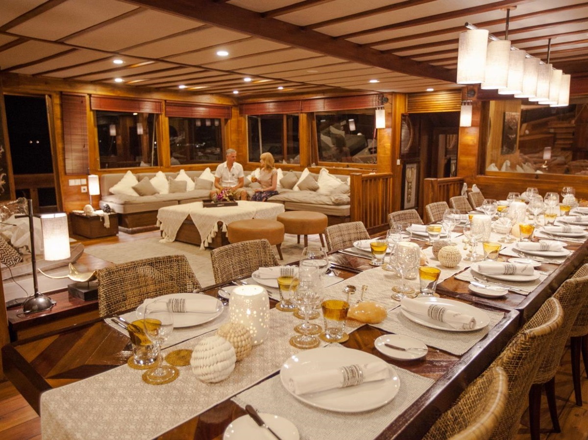 Indoor dining area onboard the Prana phinisi in Indonesia