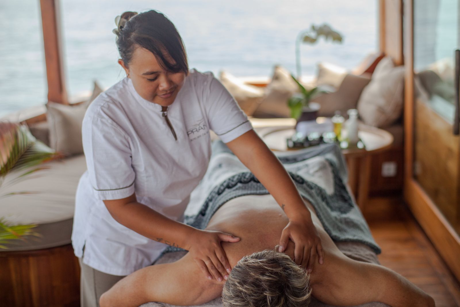 A guest enjoying a massage onboard the Prana phinisi in Indonesia