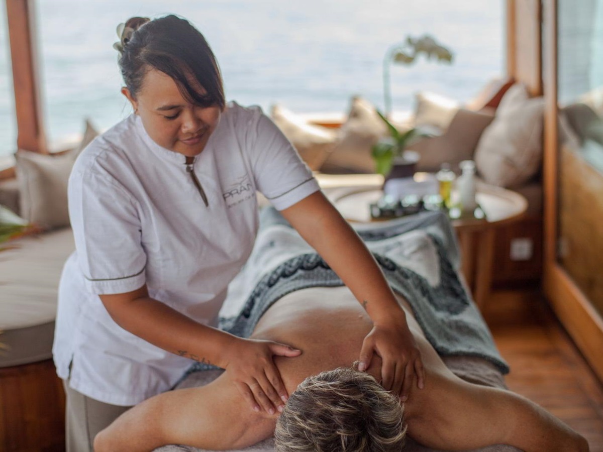 A guest enjoying a massage onboard the Prana phinisi in Indonesia