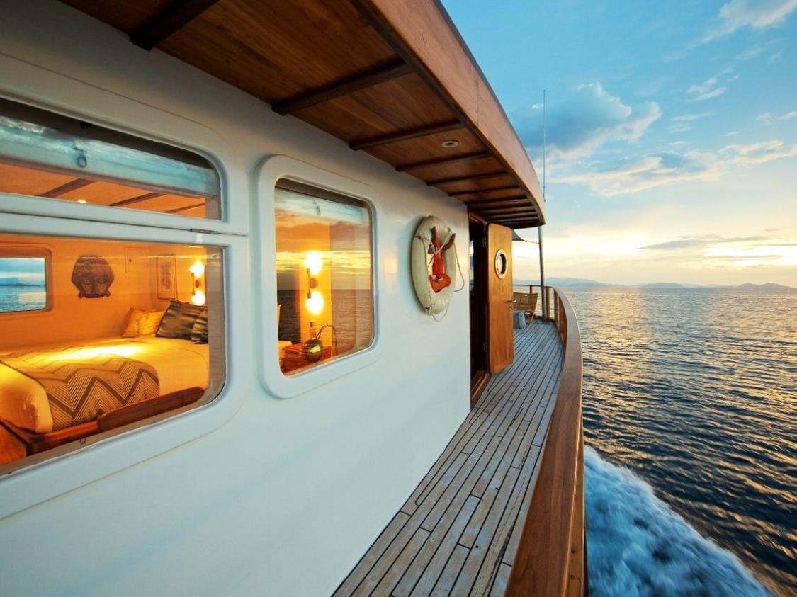 Side decking and view into Bedroom on Rascal at sunset in Indonesia
