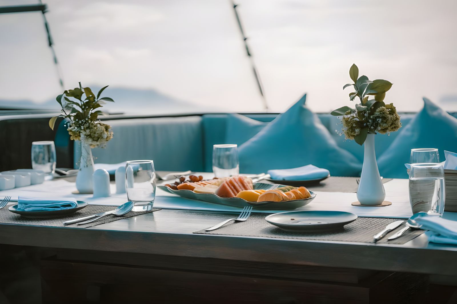 Outdoor dining table onboard the Samsara Samudra phinisi in Indonesia