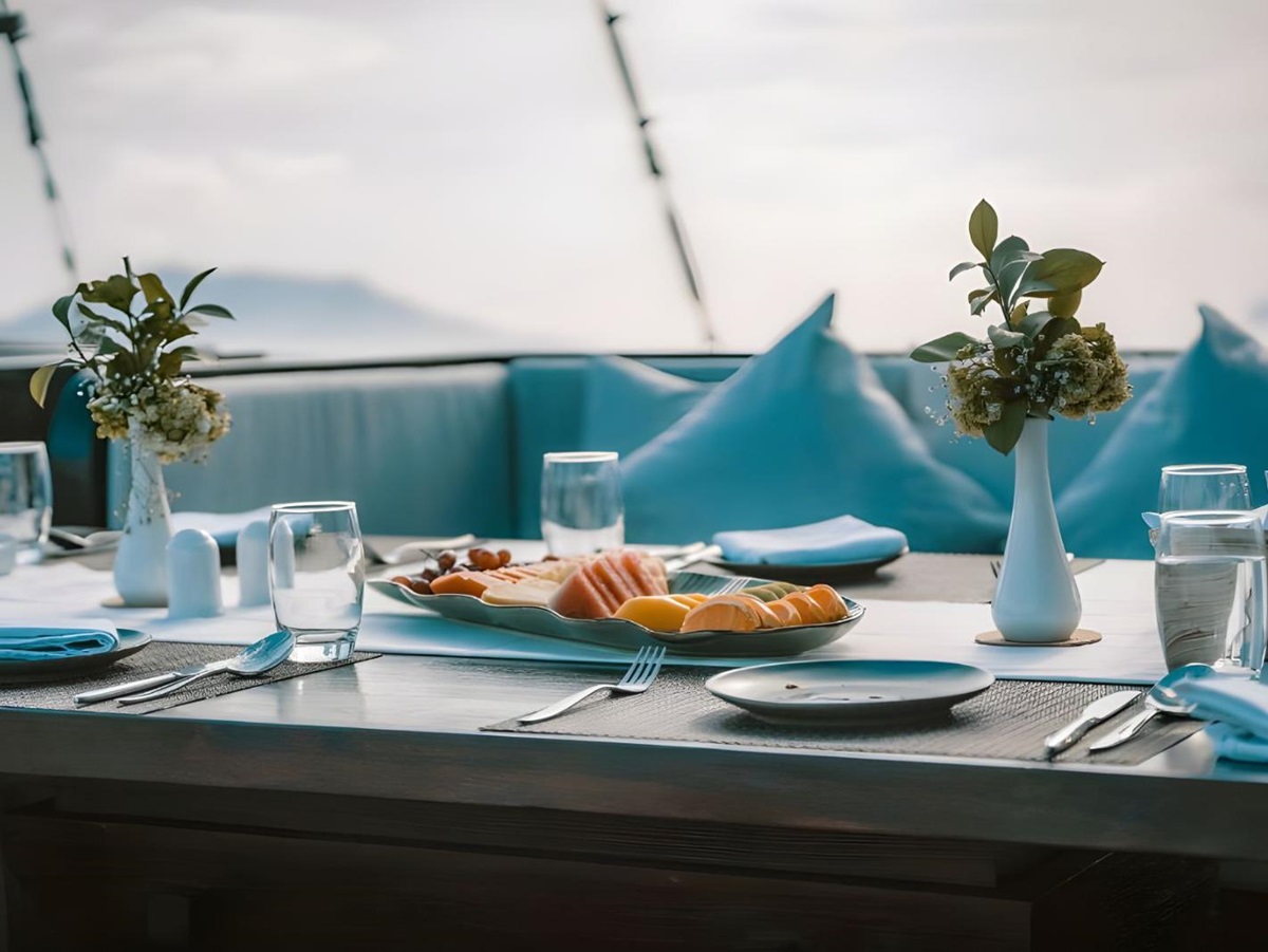 Outdoor dining table onboard the Samsara Samudra phinisi in Indonesia