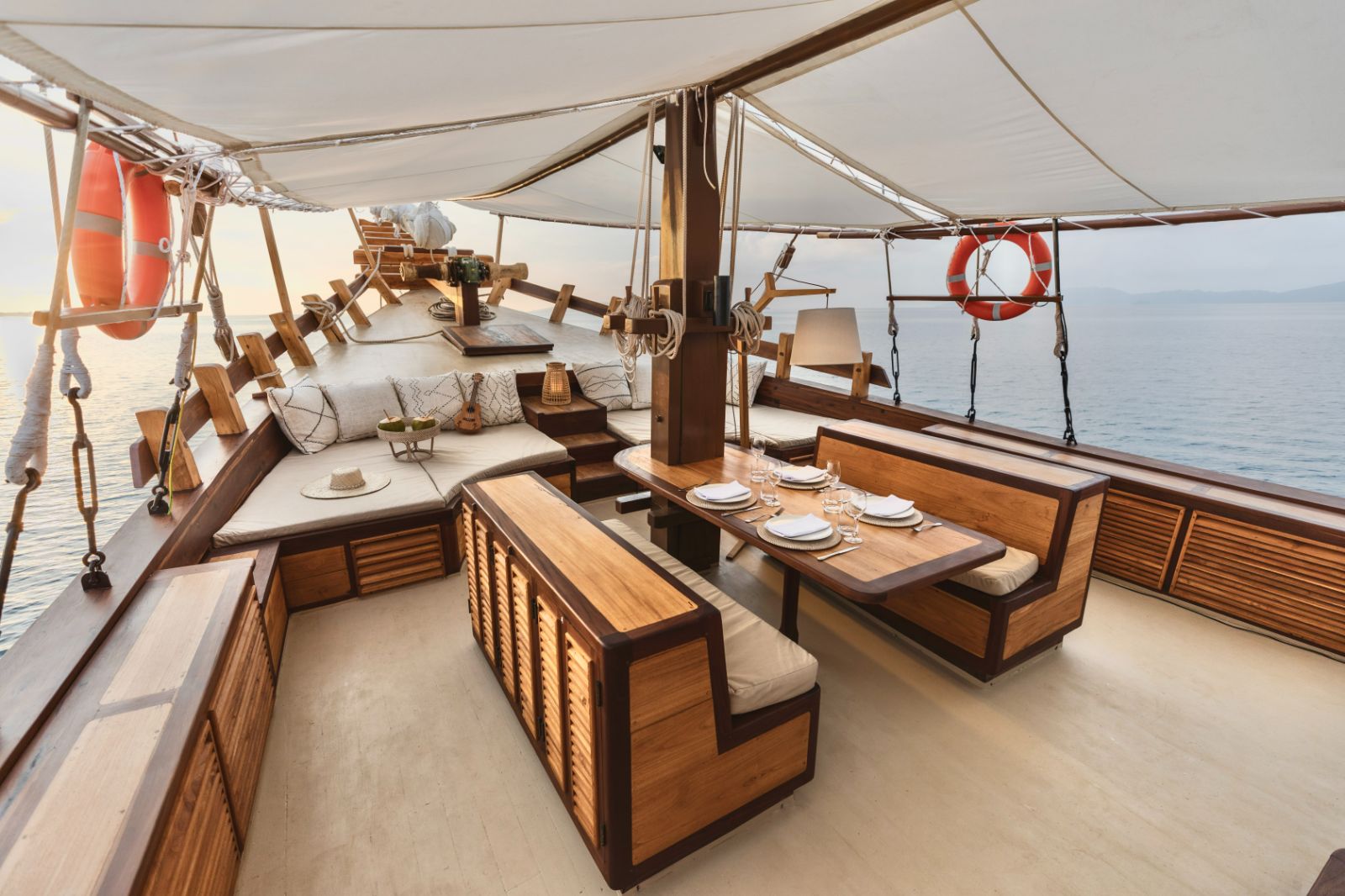 Alfresco dining area and outdoor lounge onboard the Senja phinisi in Indonesia