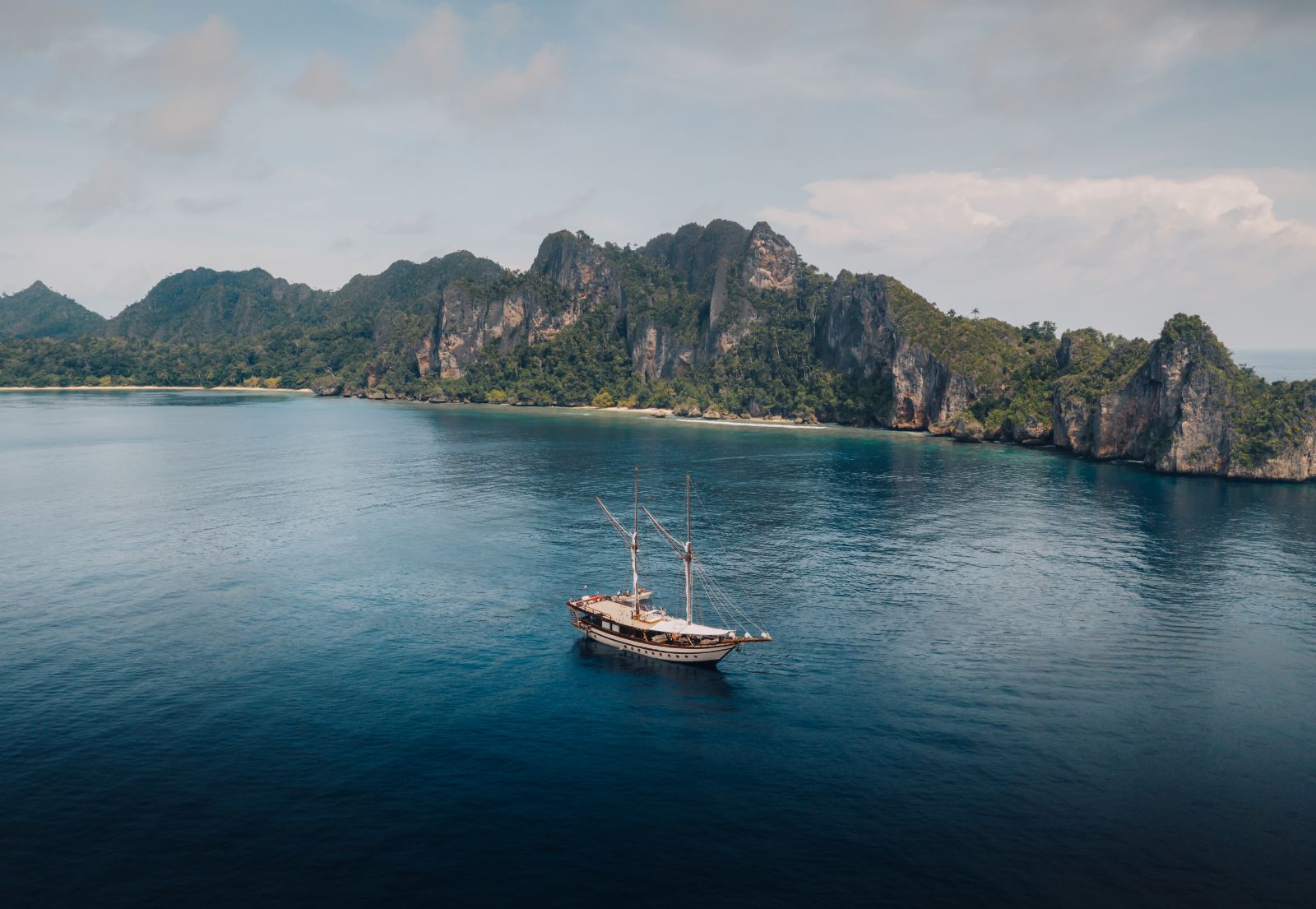Aerial long shot of the Senja phinisi in Indonesia