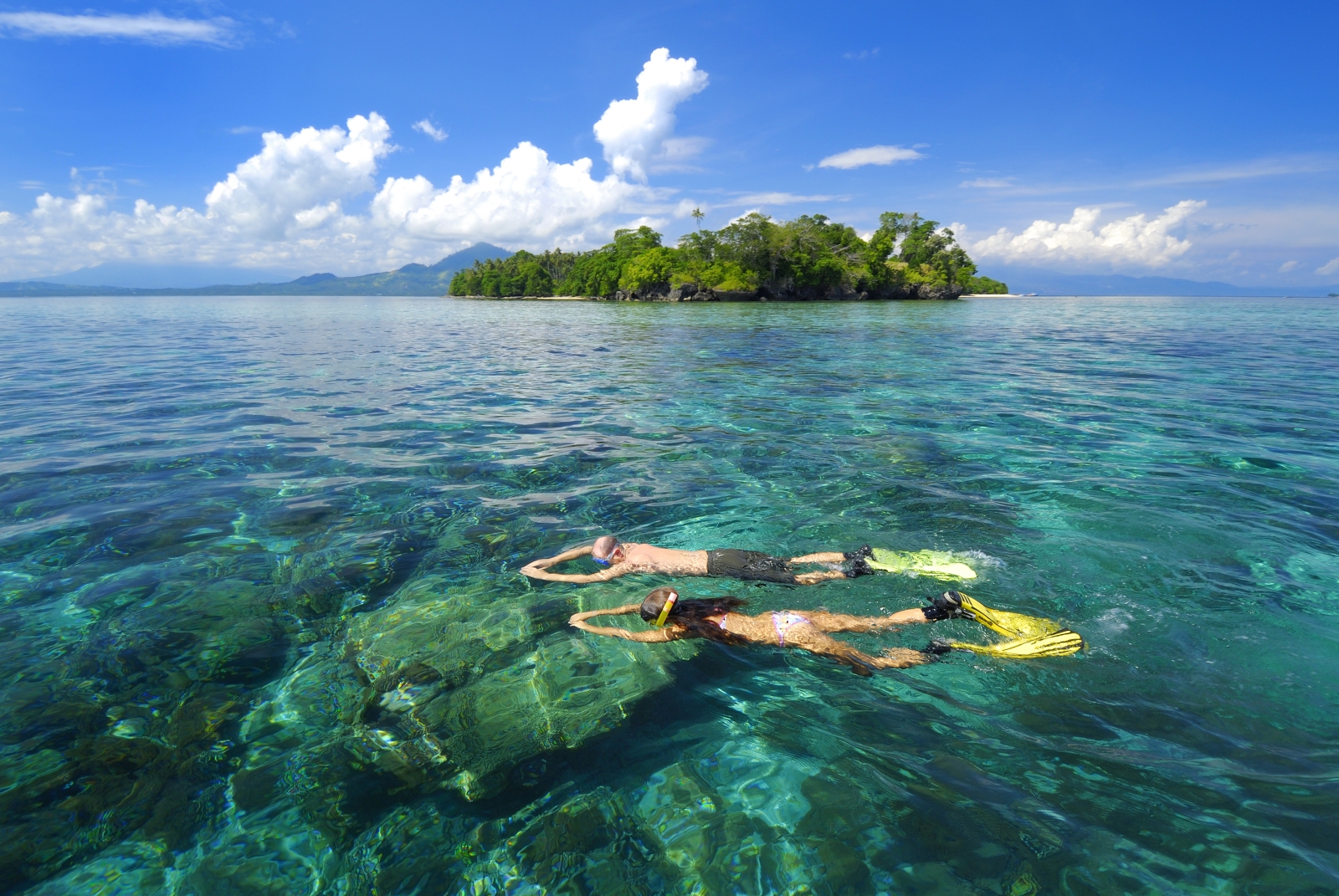 Two snorkellers snorkelling at hotel Siladen in Indonesia