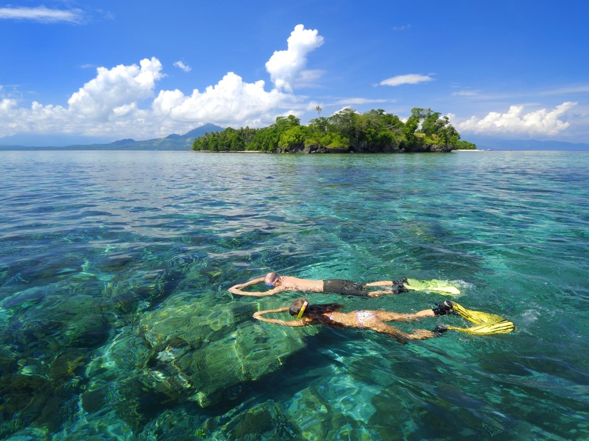 Two snorkellers snorkelling at hotel Siladen in Indonesia