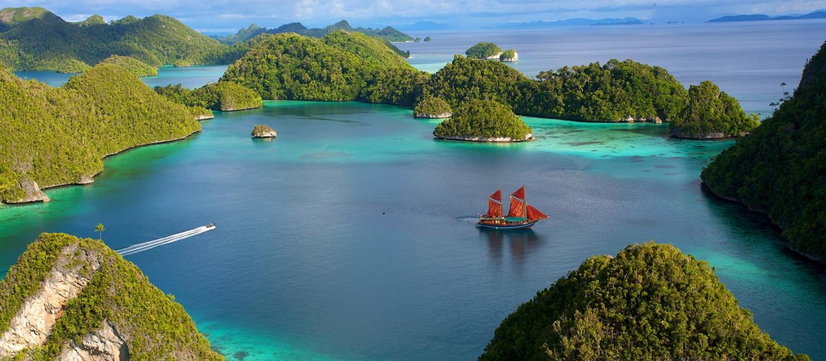 traditional timber Phinisi boat Tiger Blue in indonesia anchored at pulau wayag, raja ampat indonesia