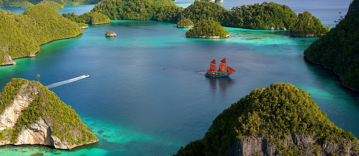 traditional timber Phinisi boat Tiger Blue in indonesia anchored at pulau wayag, raja ampat indonesia