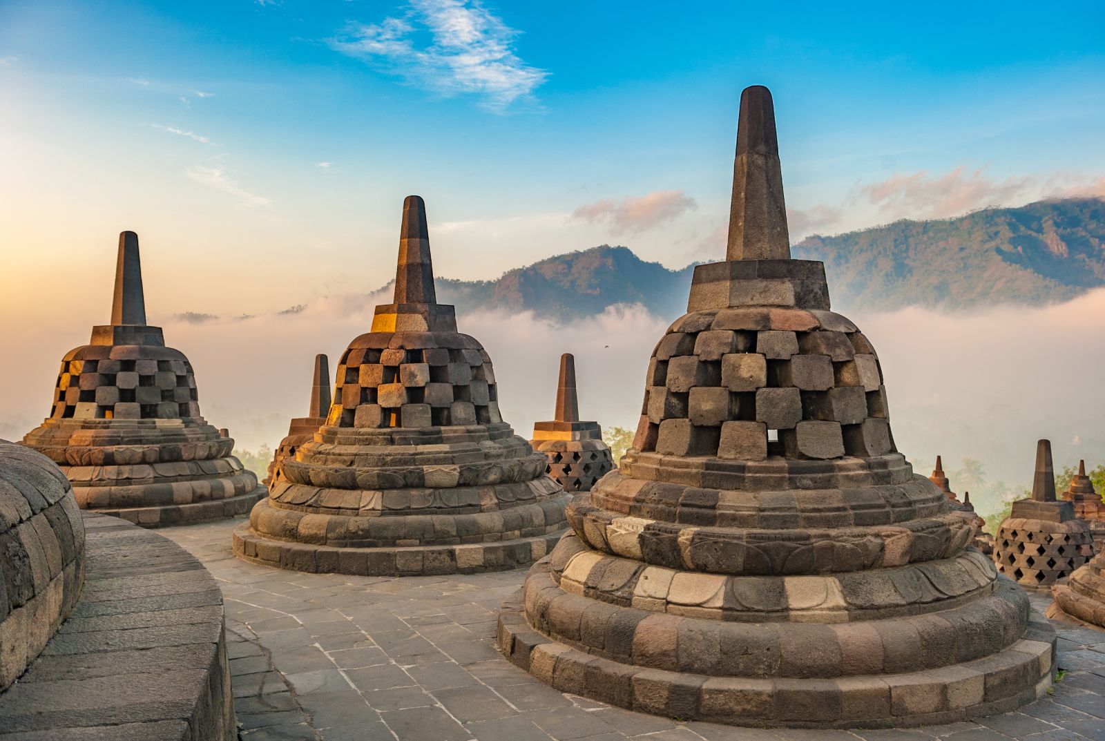 The pagodas of Borobudur in Indonesia in the morning mist