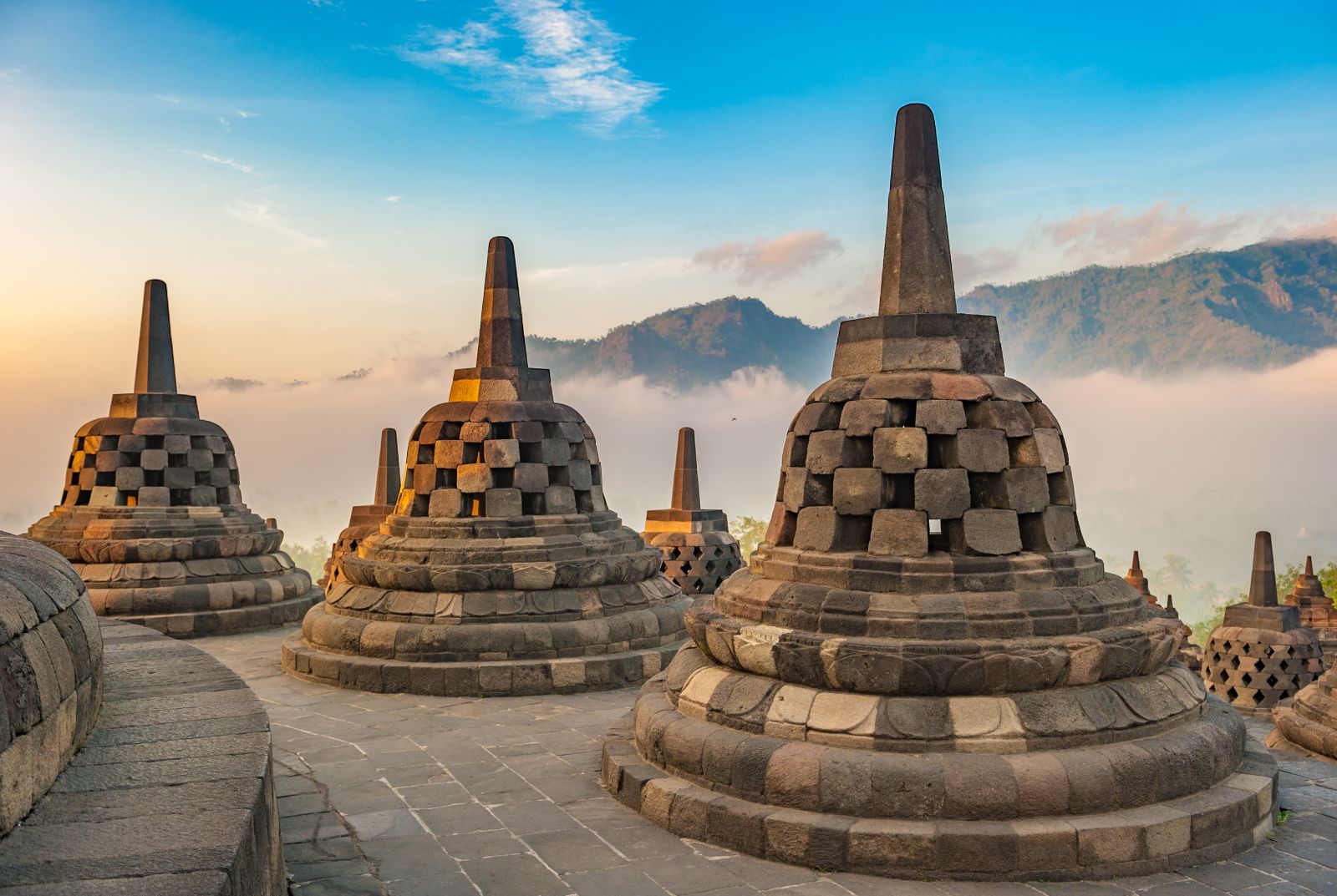 The pagodas of Borobudur in Indonesia in the morning mist