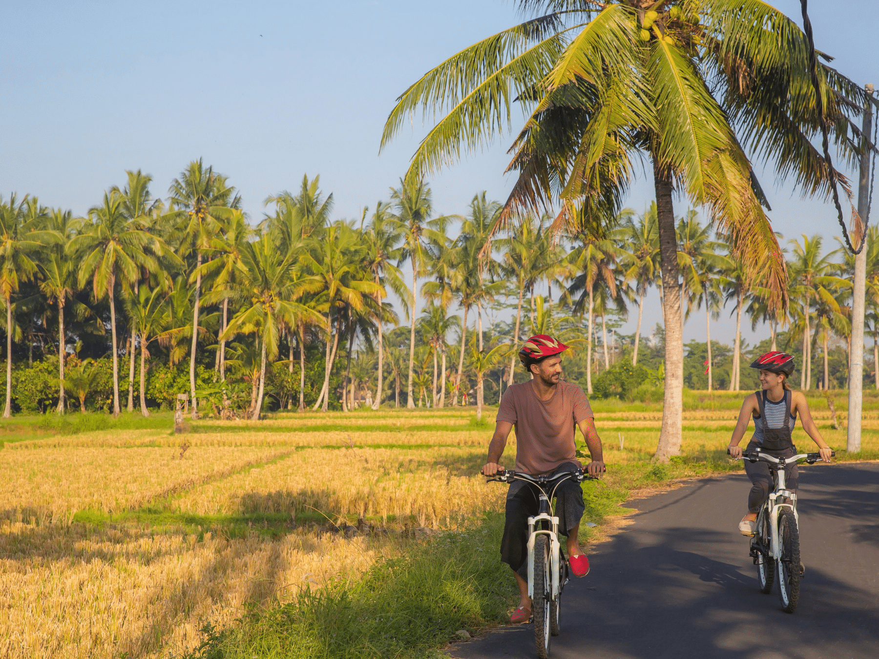 Couple cycling in Bali, Indonesia