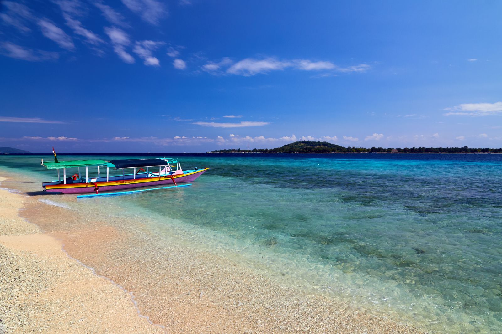 Sandy beach and fishing boat on the Gili Islands in Indonesia