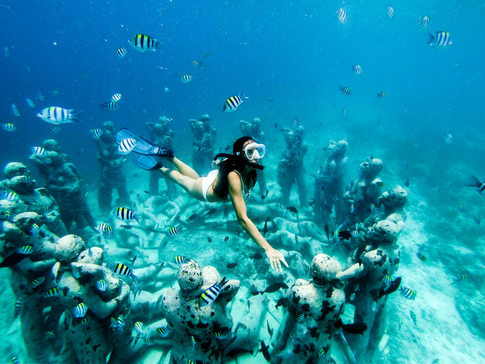 Snorkelling around the ruins of a submerged temple from the Gili Islands in Indonesia