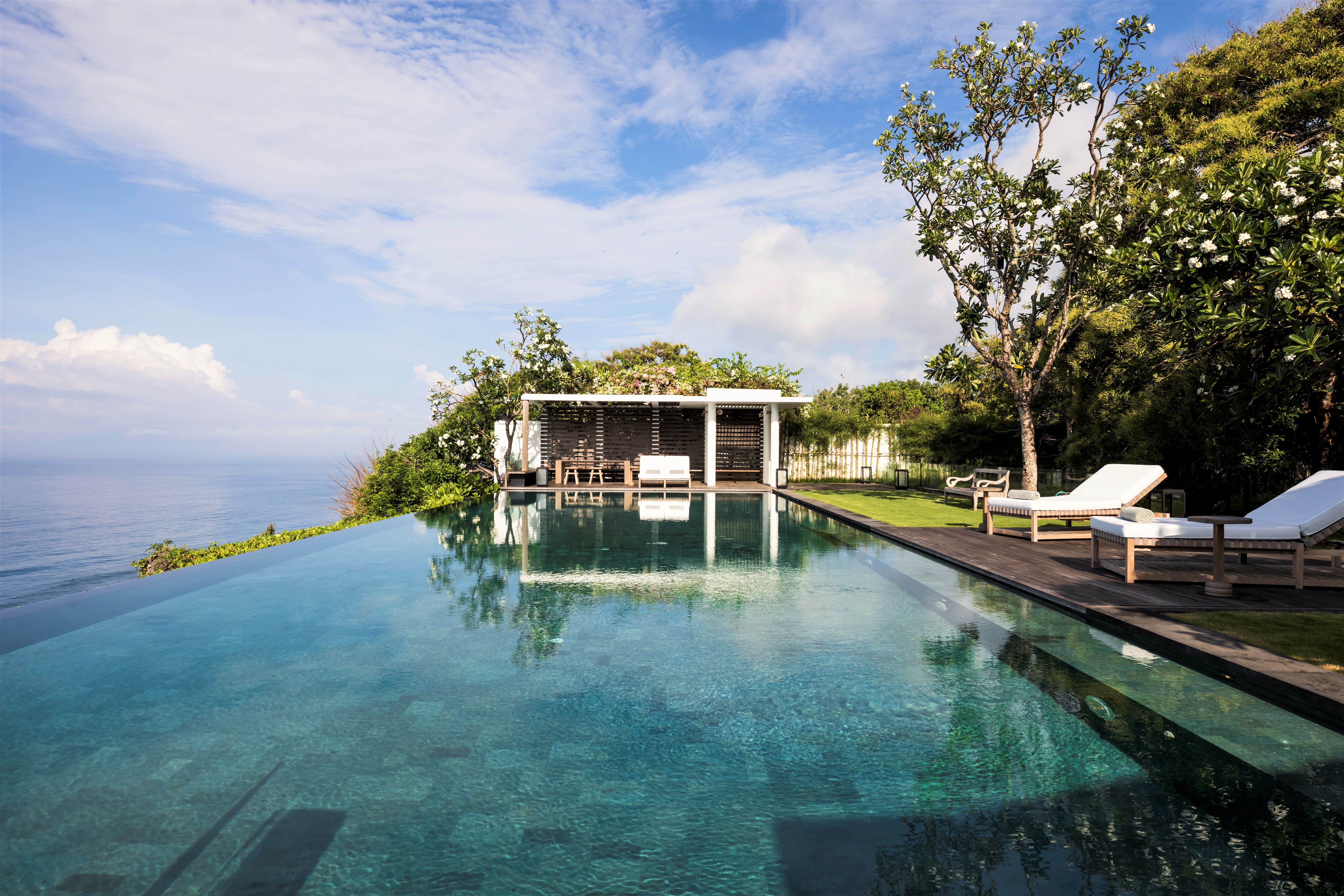 Seating area by the infinity pool at Uluwatu Estate, Bali