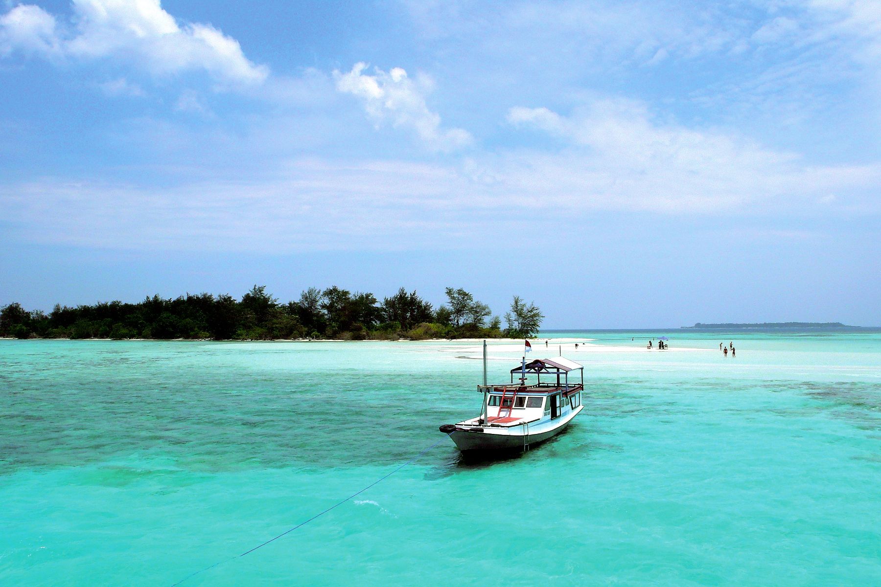 A boat moored at Robinson Crusoe Island near Kura Kura Resort in Indonesia