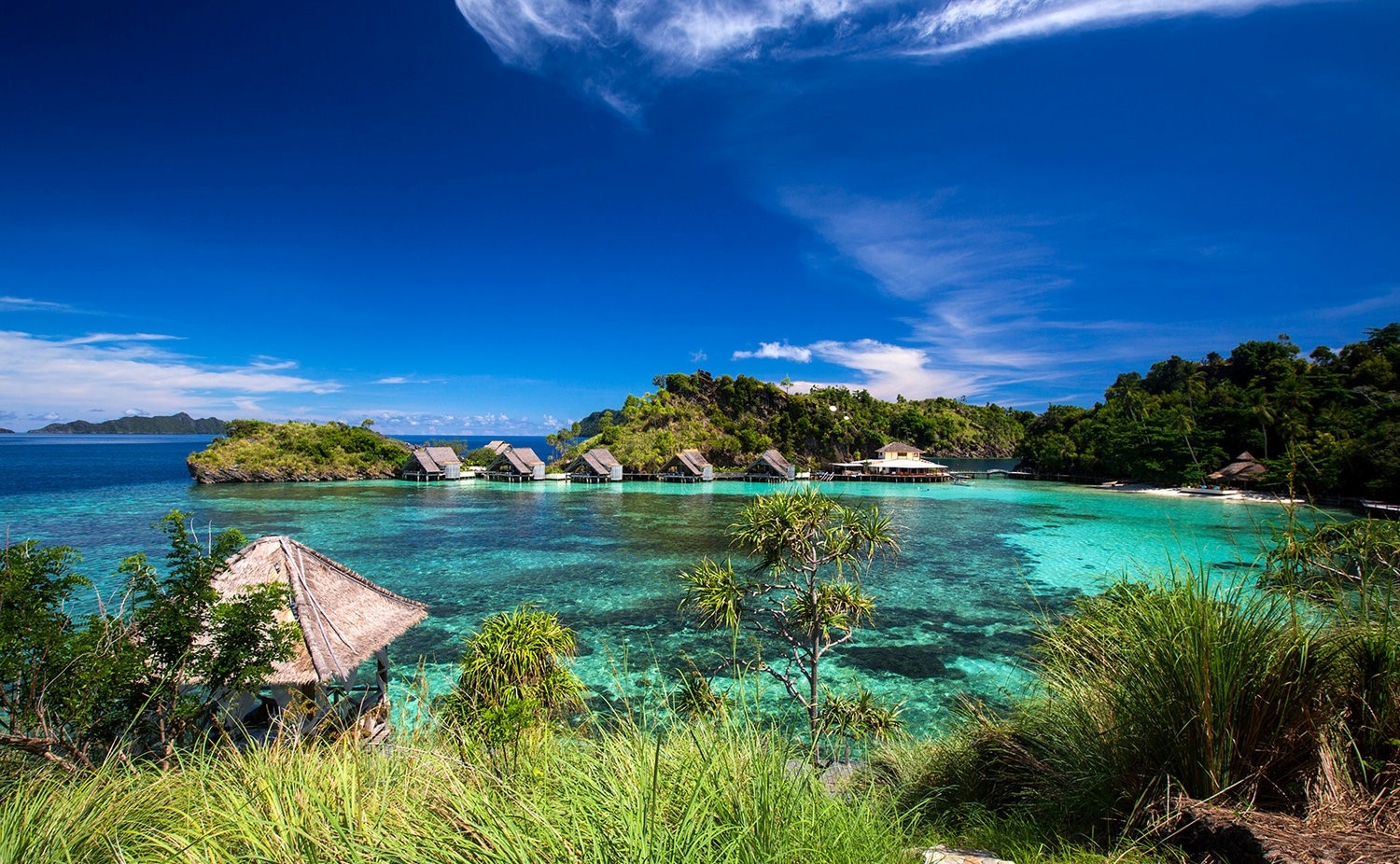 Wide angle shot of Misool Eco-resort with villas and lagoon 