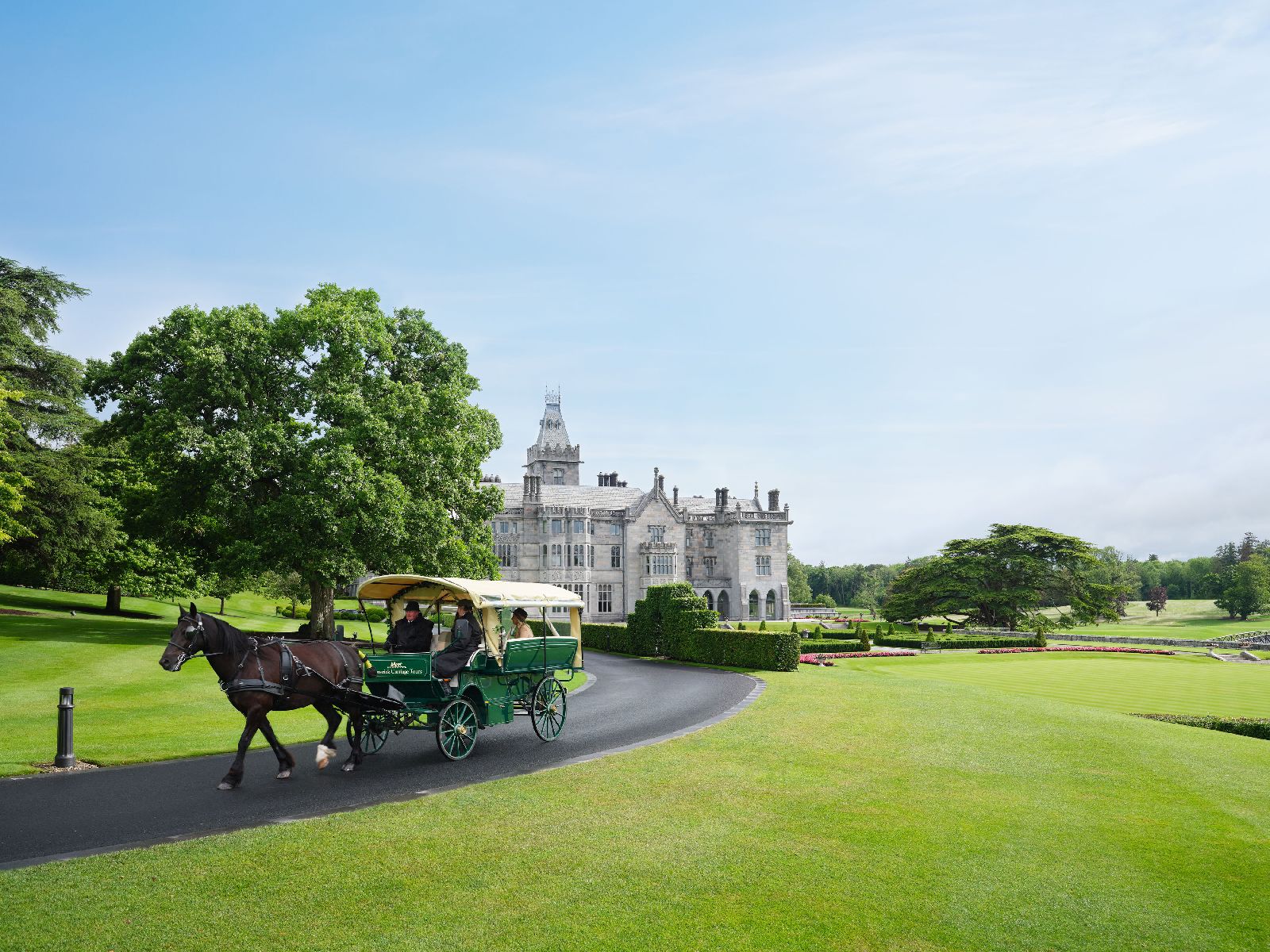 Guests on horse and carriage ride around the grounds of Adare Manor near Limerick in Ireland