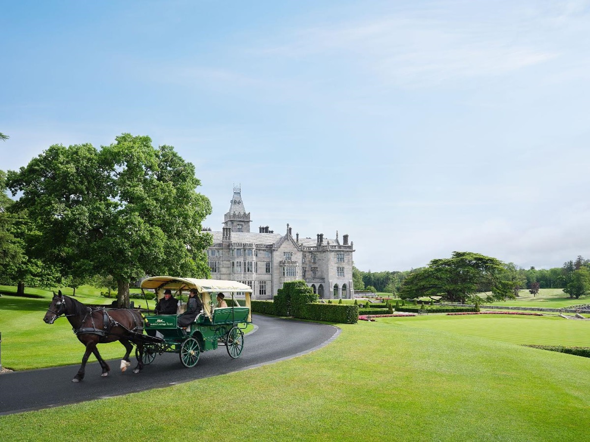 Guests on horse and carriage ride around the grounds of Adare Manor near Limerick in Ireland