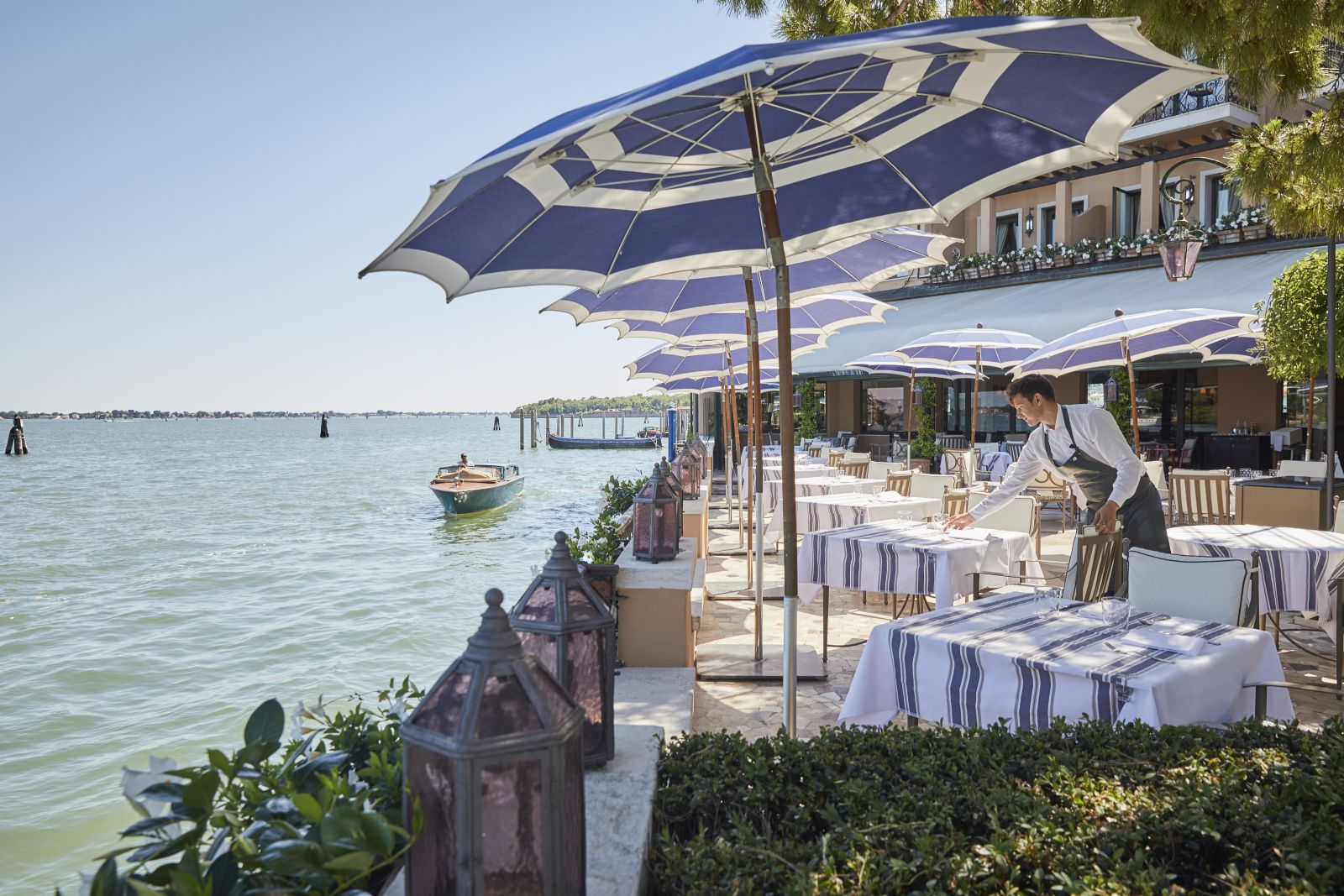 Outdoor dining with river views at Belmond Hotel Cipriani in Venice