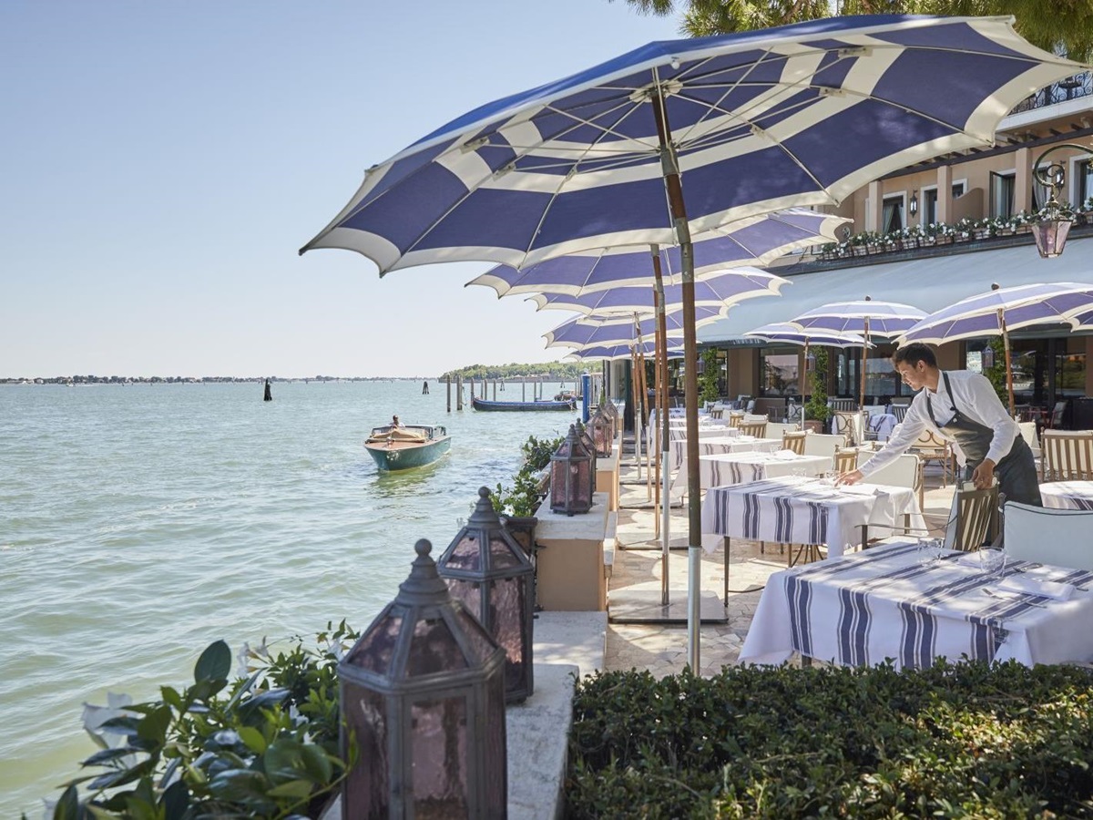 Outdoor dining with river views at Belmond Hotel Cipriani in Venice
