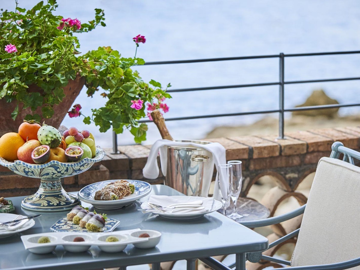 Dining on the terrace at Belmond Villa Sant'Andrea in Sicily