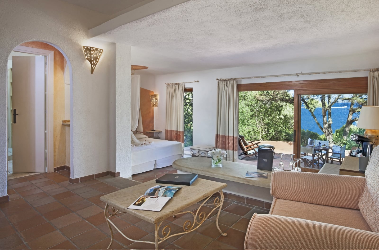 Junior Suite with sitting are aand private terrace with sea views at luxury hotel Capo d'Orso on Sardinia, Italy