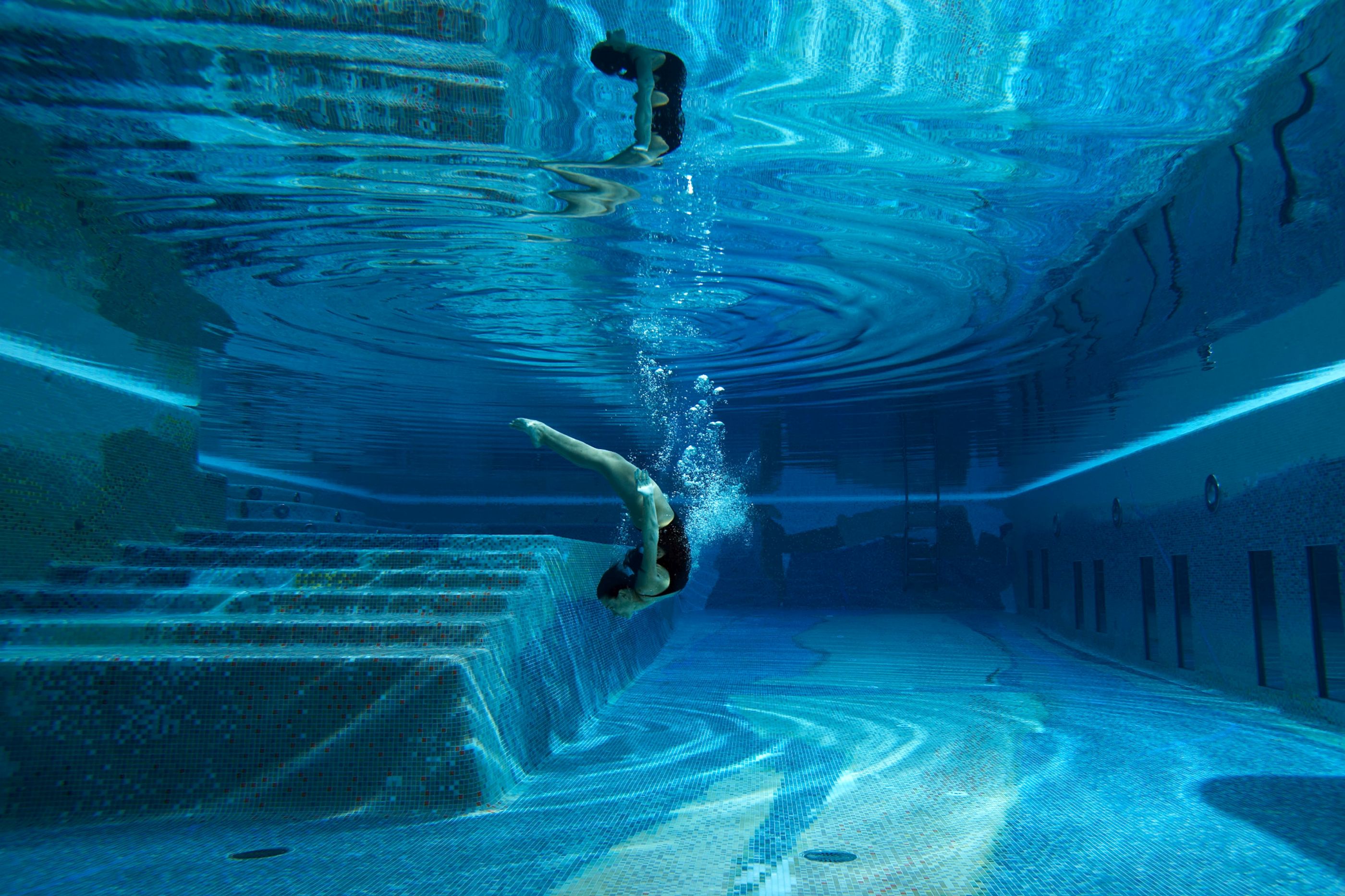 Girl diving into the swimming pool of Capri Palace Hotel & Spa, Italy