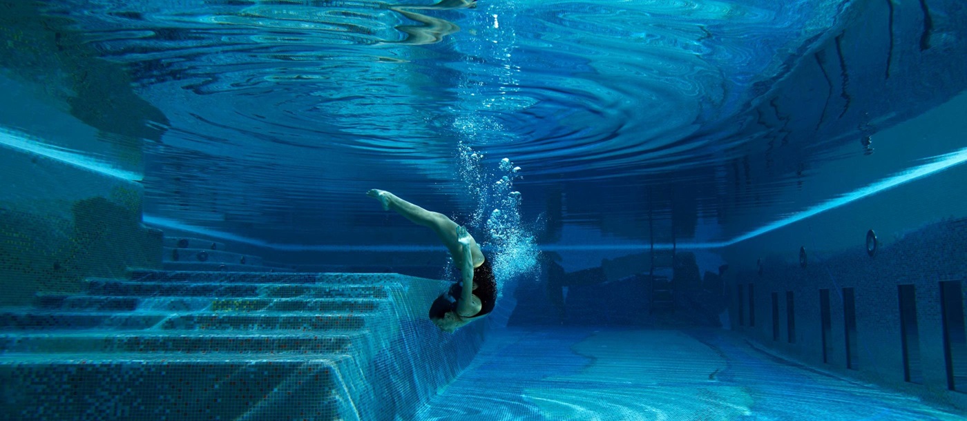 Girl diving into the swimming pool of Capri Palace Hotel & Spa, Italy