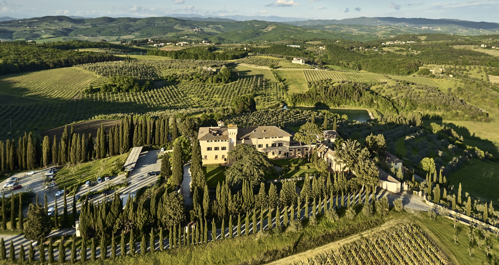 Aerial view over luxury resort COMO Castello del Nero in Italy and surrounding countryside
