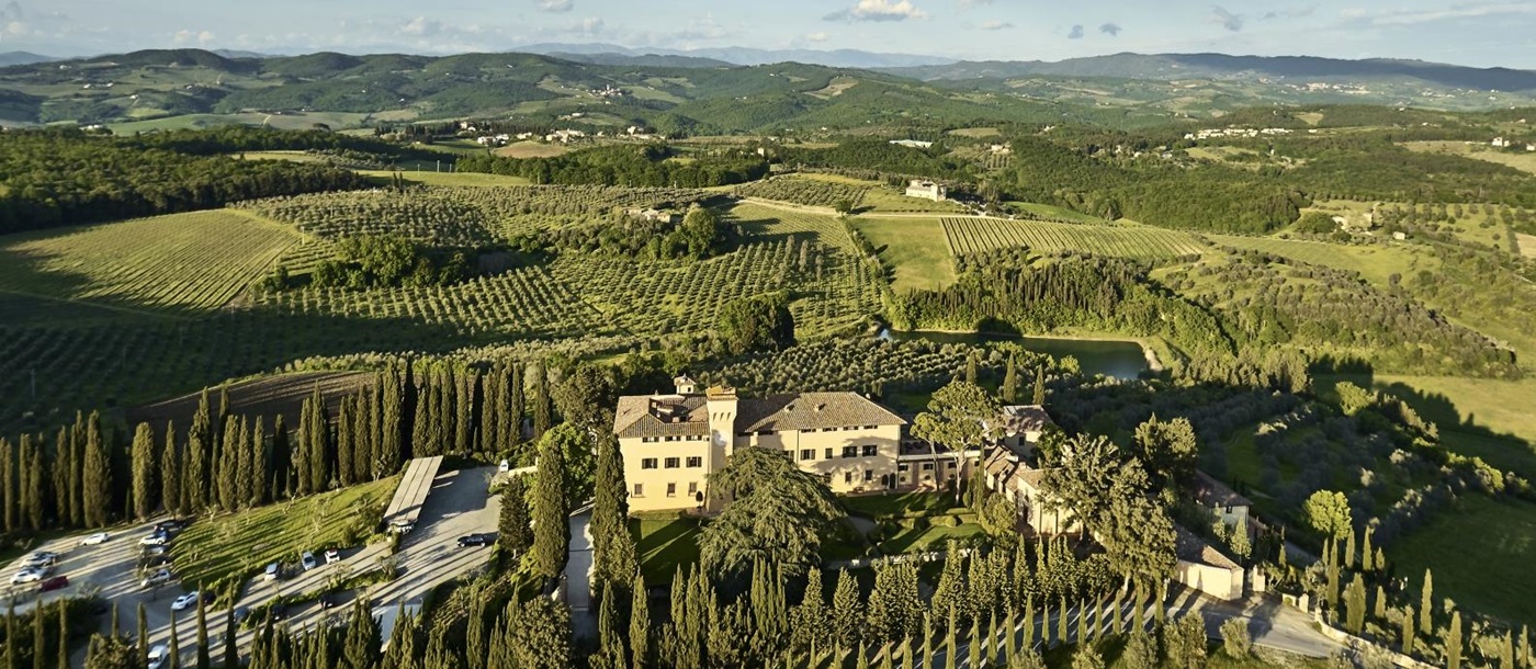 Aerial view over luxury resort COMO Castello del Nero in Italy and surrounding countryside