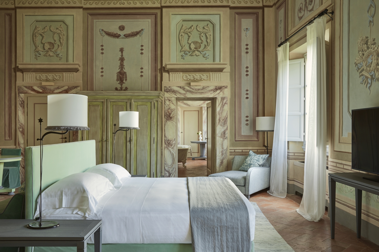 Bedroom of a Heritage Suite at luxury resort COMO Castello del Nero in Italy