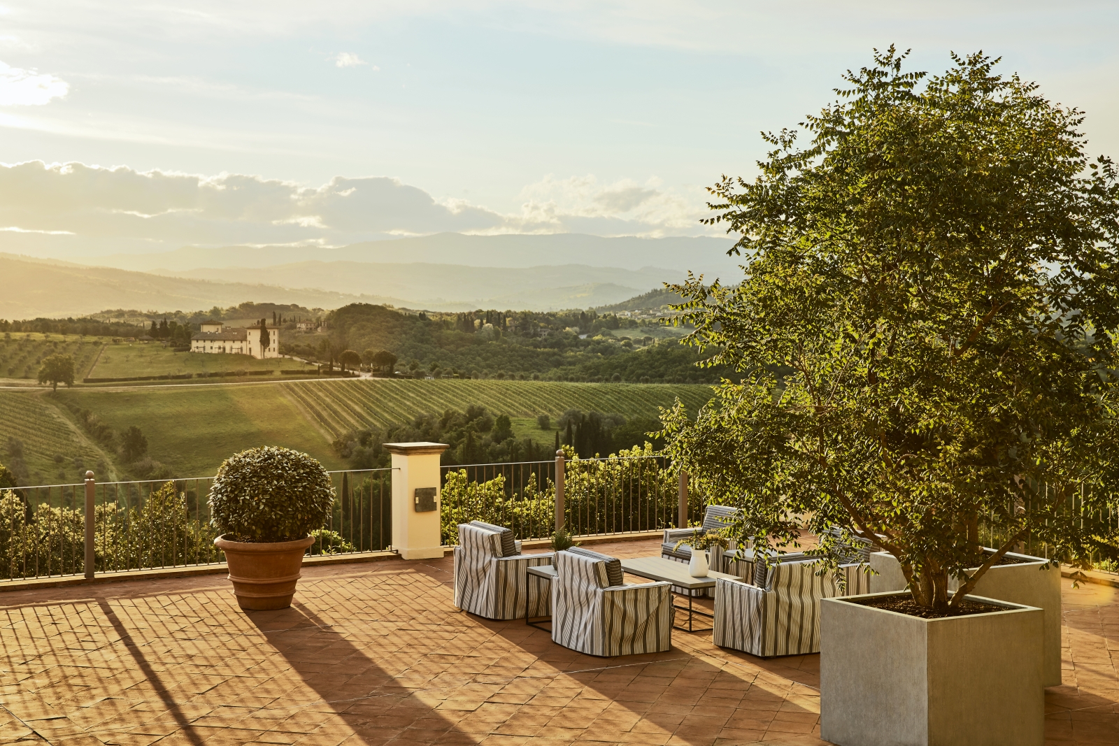 Panoramic Terrace and views over the country side at sunset at luxury resort COMO Castello del Nero in Italy