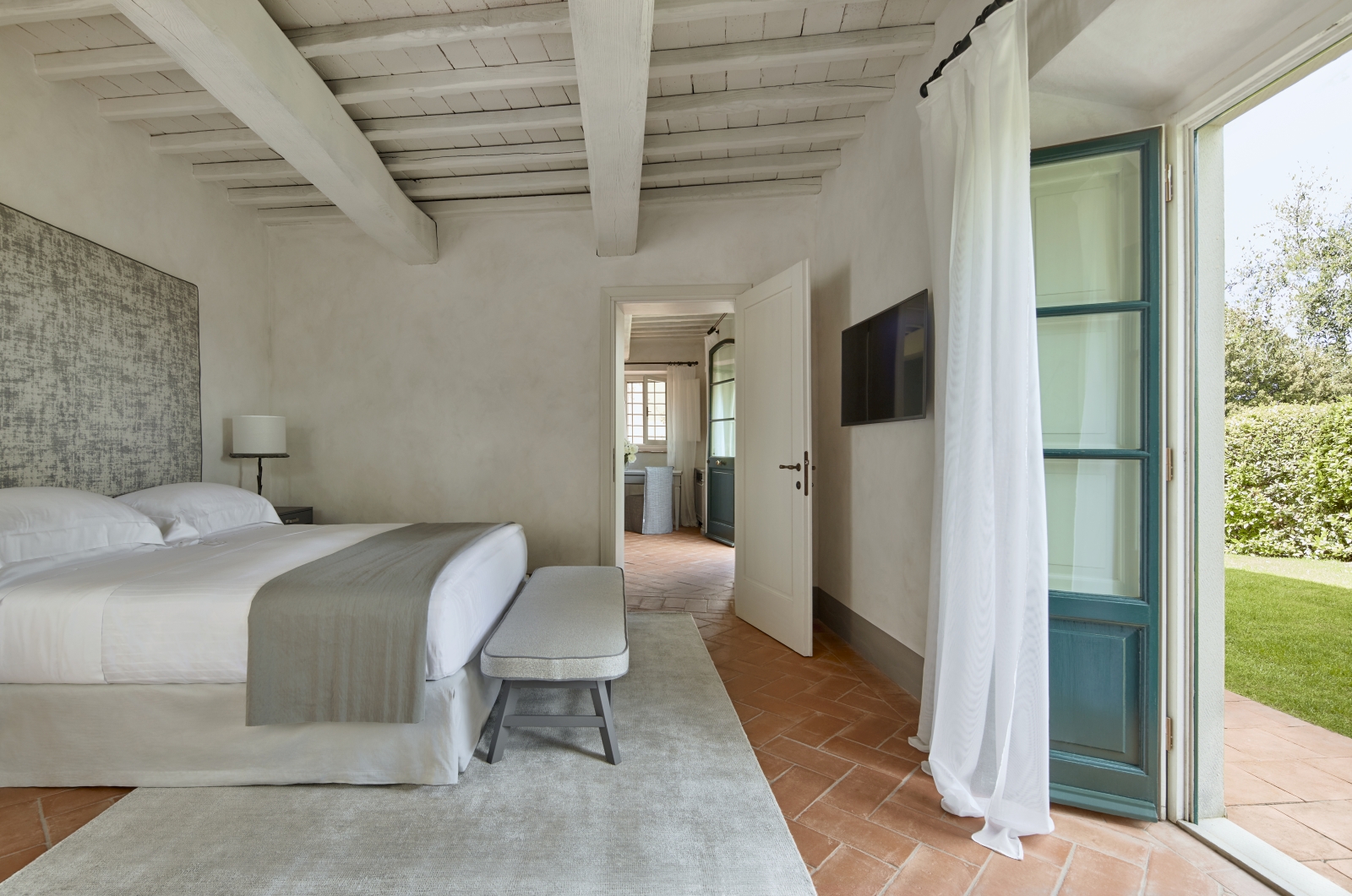 Bedroom of a Tavernelle Suite at luxury resort COMO Castello del Nero in Italy