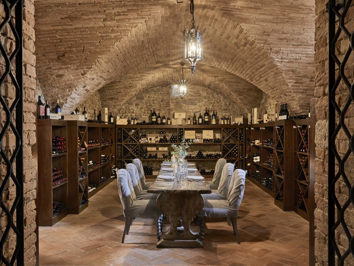 Private dining in the wine cellar of luxury resort COMO Castello del Nero in Italy