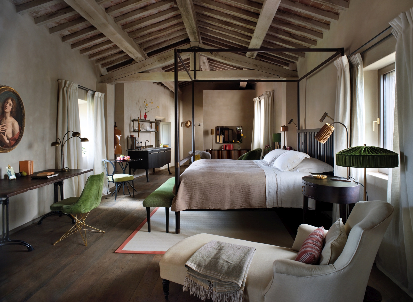 Elegantly rustic bedroom at luxury hotel Castello di Reschio in Umbria, Italy, with four poster bed, desk space and large windows