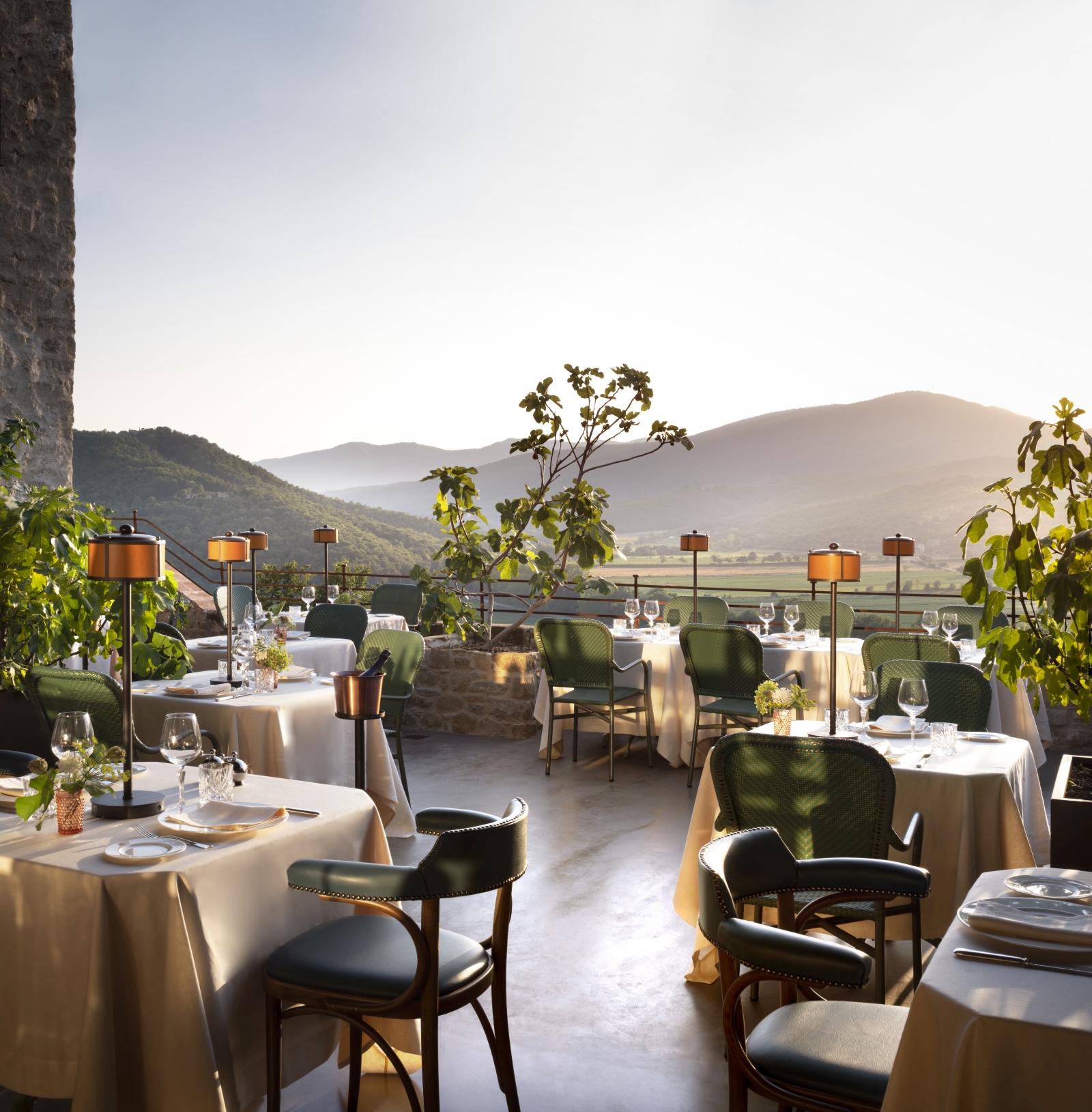 Terrace dining at luxury hotel Castello di Reschio in Italy, with views over the sweeping hills of Umbria