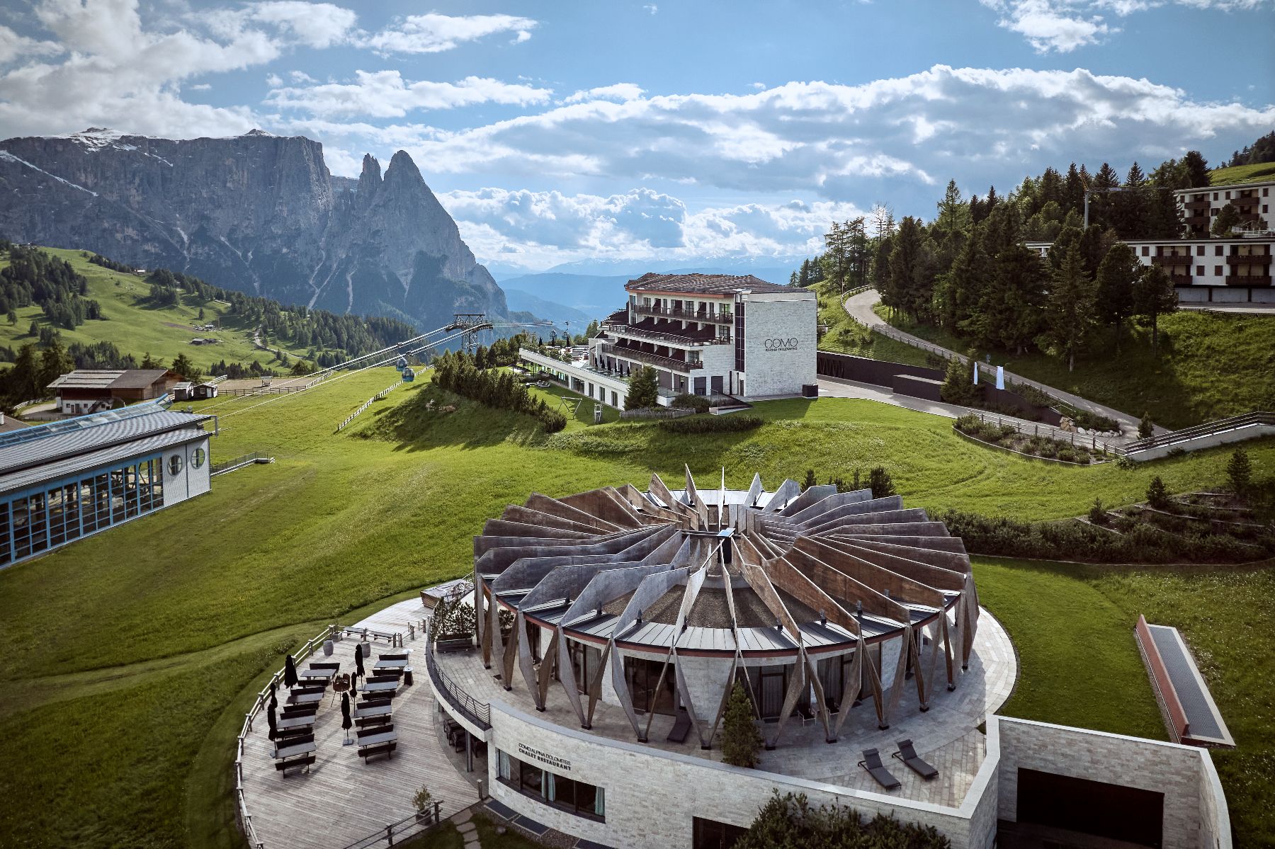 Exterior view of COMO Alpina Dolomites during the summer