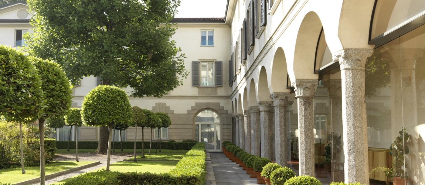 Path between arches and gardens at Four Seasons Milan
