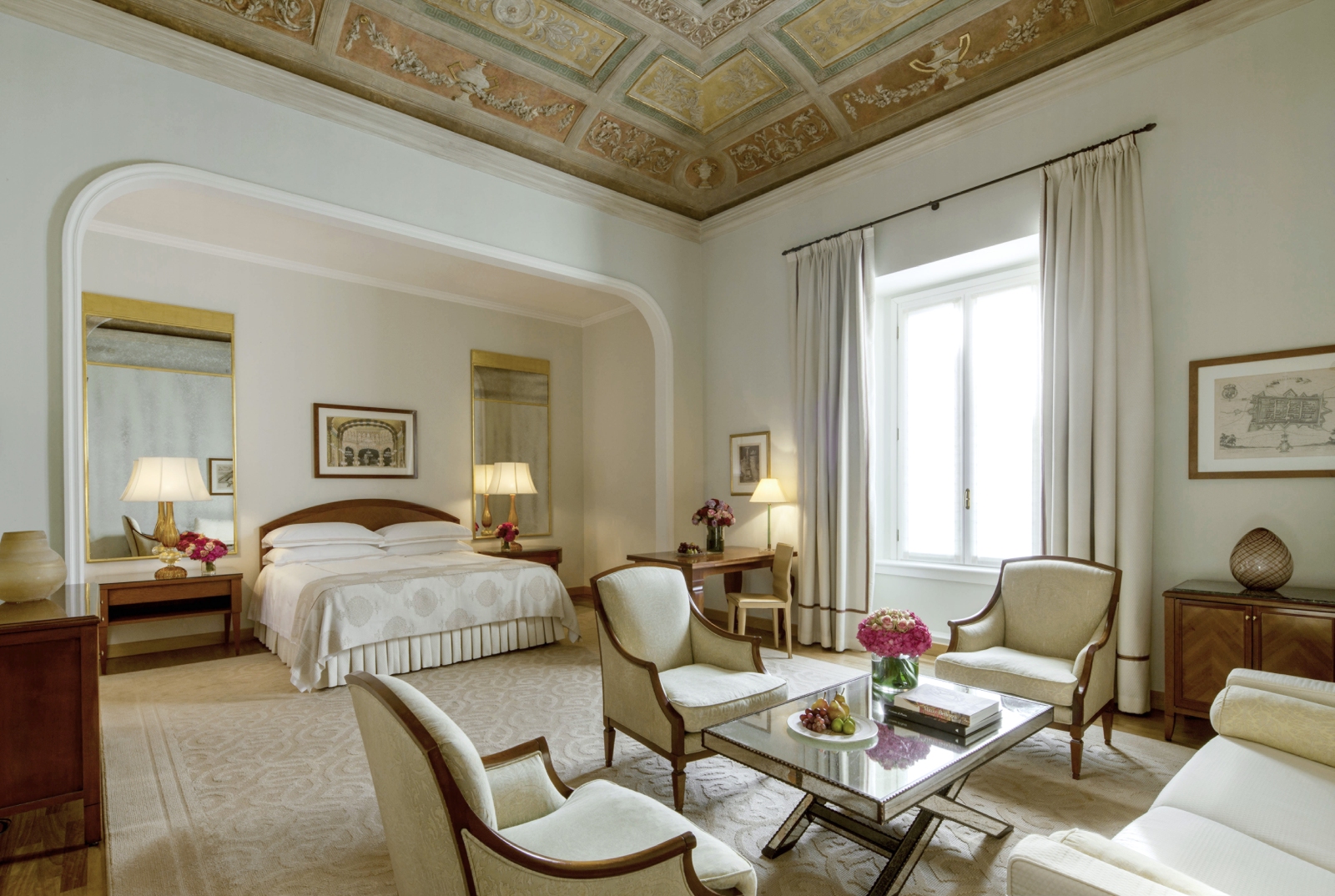 Bedroom and living area of the Fresco Suite with partial fresco on the ceiling