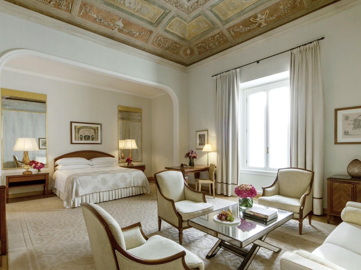 Bedroom and living area of the Fresco Suite with partial fresco on the ceiling