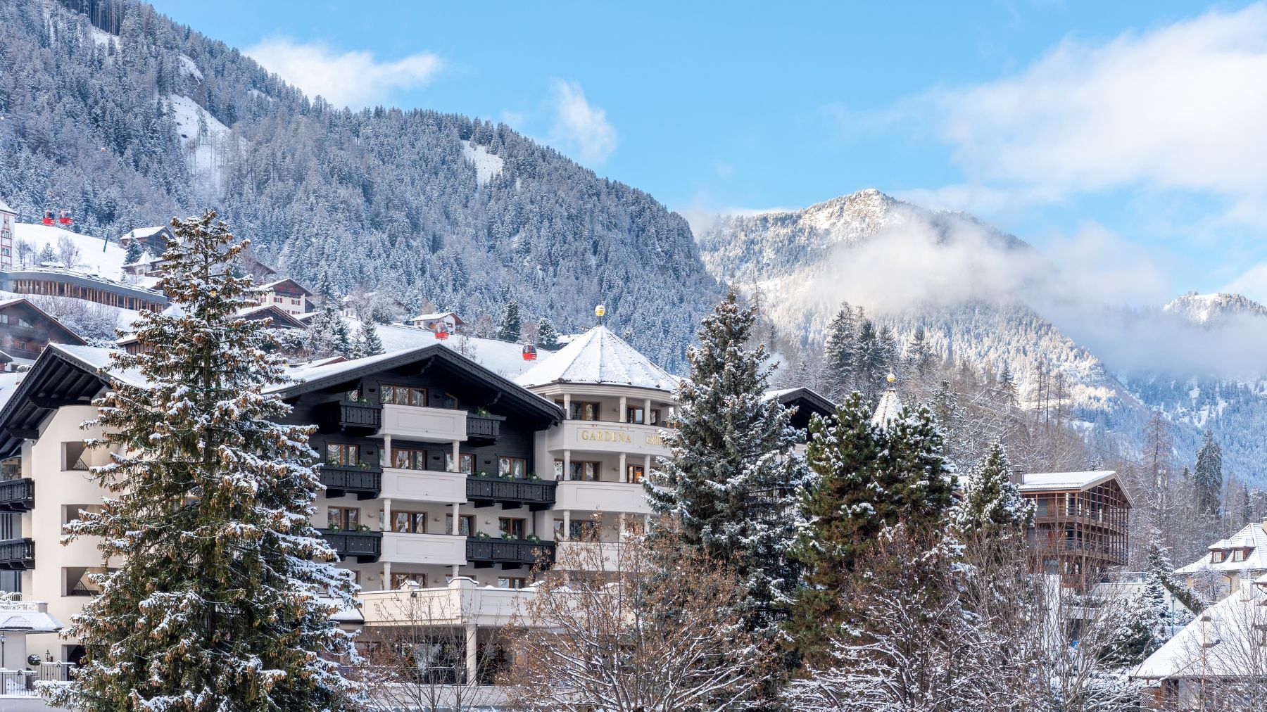 Exterior view of Gardena Grodnerhof Hotel & Spa in the Dolomites during winter