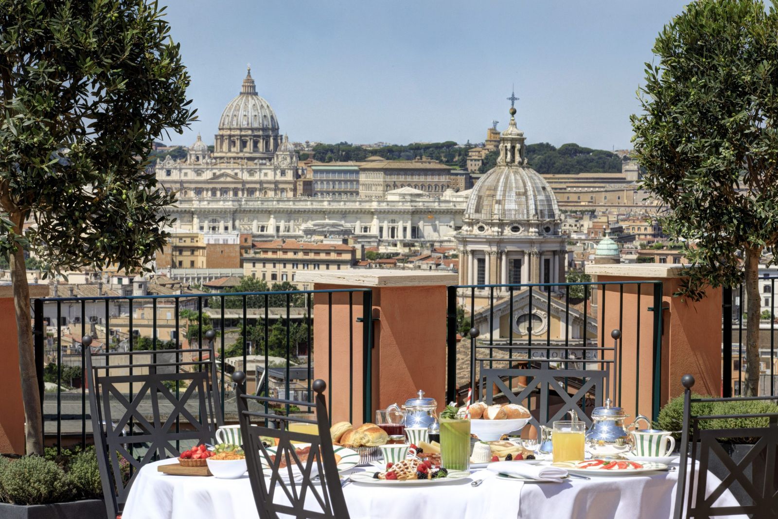 A dining table set up on the terrace at Hotel de la Ville in Rome