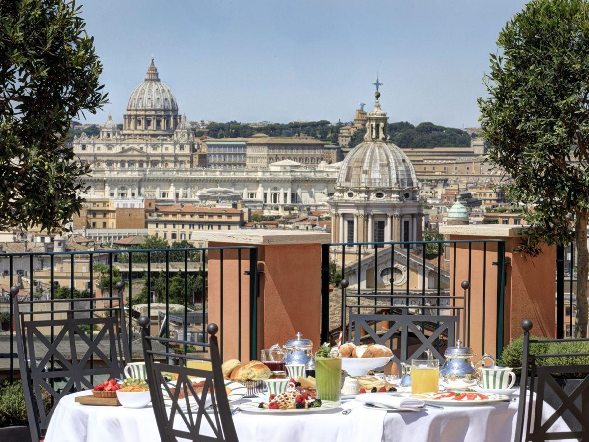 A dining table set up on the terrace at Hotel de la Ville in Rome