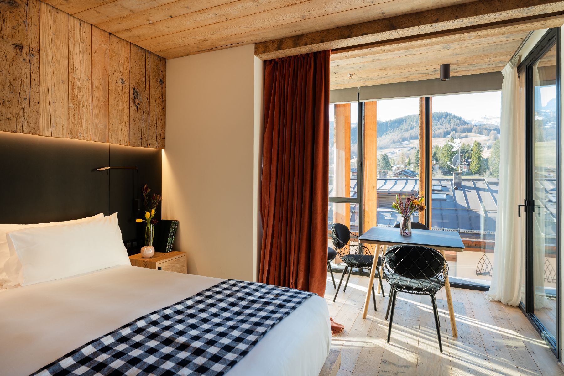 Bedroom and lounge area at Hotel de Len in the Dolomites
